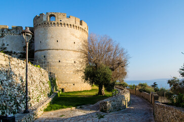 Fototapeta na wymiar Un torrione del castello di Castro, borgo marinaro del Salento in Puglia, illuminato dalla luce del tramonto