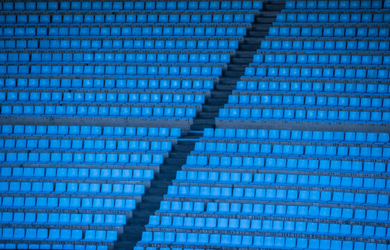 Full frame view of rows of empty blue seats in a sports stadium
