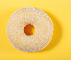 Top view of donut on yellow background