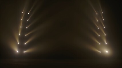 Beams of side spotlights with white soft light illuminating a dark smoky scene. Concert empty stage...