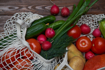 Healthy food vegetables in Eco-friendly packaging reusable bag on wooden table background.