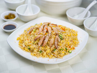 Closed up of Crab meat fried rice served on white porcelain plate