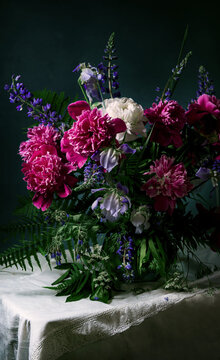 Flowers arrangement. Classic still life with beautiful purple peony and lupin flowers bouquet in white jug. Art photography. beautiful bouquet of autumn flowers in the Dutch style.