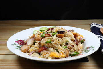 Traditional fried rice with pork sausage  serving on the plate. Famous street food menu in Asia restaurant.