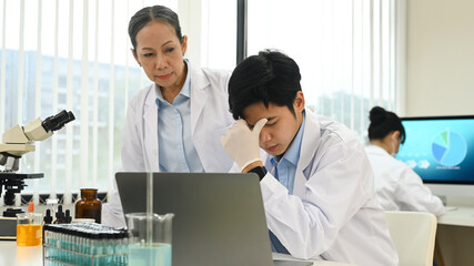 Fototapeta premium Senior woman comforting stressed male having problems results of the experiment