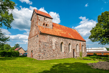 Fototapeta na wymiar Catholic church St. Antoni of Padua in Buk, West Pomeranian voivodeship, Poland.The church was erected in the 13th century from a granite square in the Romanesque style. 