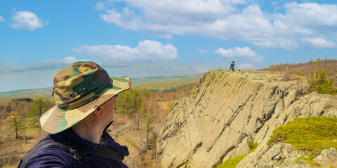 portrait of a mature male tourist on top of a mountain range