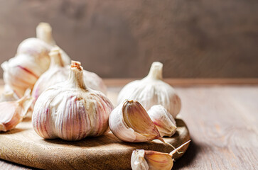 Garlic bulbs on a wooden background. Copy space.