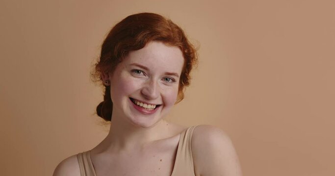 Beauty woman laughing isolated portrait. Ginger woman model with smooth skin