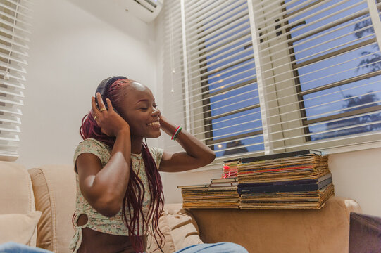 A woman listening to music and smiling 