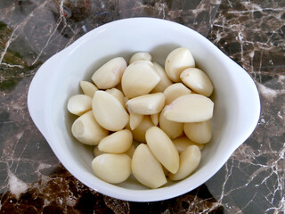 Garlics of white plate. Close-up