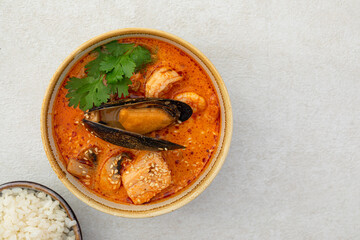 Closeup on tom yam seafood soup with rice