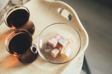 Turkish tea and dessert on a tray on white background.