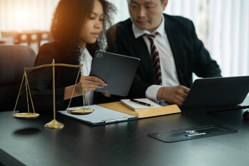 Lawyers discuss agreements with clients or staff at the office.