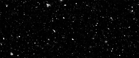 Falling snow isolated on black background. Falling snow at night. Bokeh lights on black background, flying snowflakes in the air. Winter weather. Overlay texture.