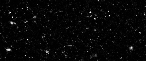Falling snow isolated on black background. Falling snow at night. Bokeh lights on black background, flying snowflakes in the air. Winter weather. Overlay texture.