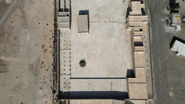 A camera drone fies backward over Aqeer (Al Uqayr) Castle, Saudi Arabia