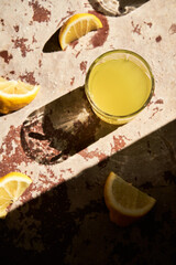 Traditional italian homemade lemon alcohol drink liqueur limoncello with pieces of lemon