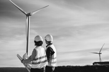 Engineers working at alternative renewable wind energy farm - Eco sustainable energy industry...