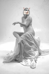Creative design. Contemporary art collage. Beautiful young woman posing naked on transparent cloth....