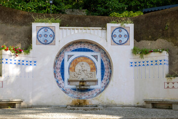 Narrow streets of Sintra village with ancient azulejo fountain