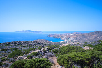 Naklejka na ściany i meble Breathtaking panoramic view of the famous Mylopotas beach in Ios Greece and the island of Sikinos in the background
