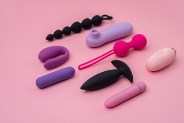 Variety of sex toys on a pink background - obrazy, fototapety, plakaty