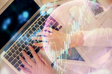 Double exposure of woman hands working on computer and forex chart hologram drawing. Top View. Financial analysis concept.