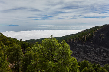 Fototapeta na wymiar Seas of clouds, lava flows, the Teide of Tenerife in the background and many more spectacular landscapes on the route of the volcanoes (Cumbre Vieja) on the island of La Palma. Canary Islands. Spain
