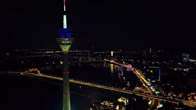 Rotation drone shot around the Rhine Tower Düsseldorf with spectacular fireworks. Germany (2)