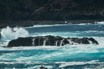 Fototapeta premium The waves break on the volcanic cliffs of La Fajana on the island of La Palma. Canary Islands. Spain