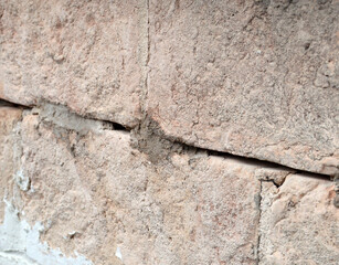 Fixation with epoxy resin mortar points of an ancient brick wall. Consolidation of an old block...
