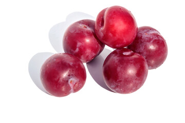 On a white isolated background red ripe tasty cherry plum.