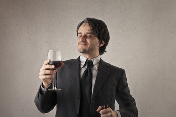 man drinks a glass of wine