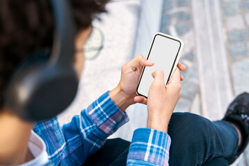 Hipster man using mobile app shopping online, selective focus, mockup. Guy holding smartphone reading text message, checking email looking at digital screen. Modern technology concept  