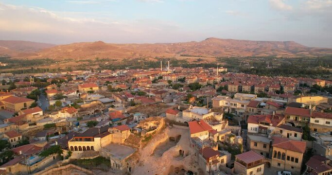 Urgup is a city and district in the central part of Turkey, on the territory of Nevsehir province. Aerial view of the city of Urgup, Cappadocia at sunset.