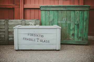 Three multi coloured wooden shipping crates