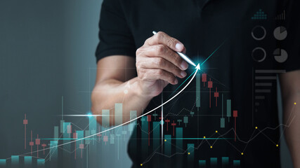 Businessman drawing a graph of stock market uptrend, stock trading and investment concept. - obrazy, fototapety, plakaty