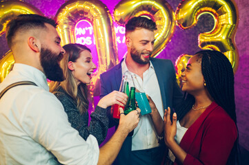 Multiracial people toasting drinks while celebrating new years eve in the club