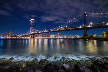View of New York City - beautiful landscape, Manhattan Bridge, waterfront at night over bridge