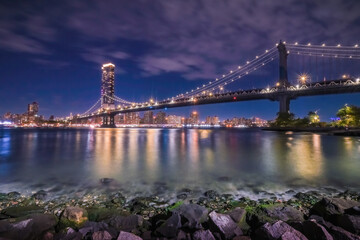 View of New York City - beautiful landscape, Manhattan Bridge, waterfront at night over bridge