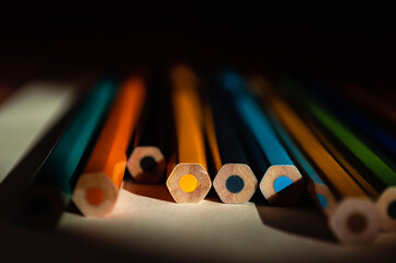 The ends of multicolored pencils. Colored pencils background. Selective focus.  