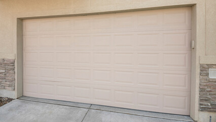 Panorama Beige sectional garage doors of a townhouses with balcony