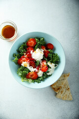 Kale salad with fresh cheese and strawberry