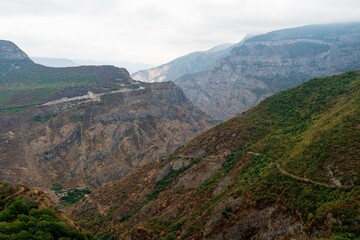 Obraz premium Foggy view of the gorge and the slopes of the Caucasian mountains.