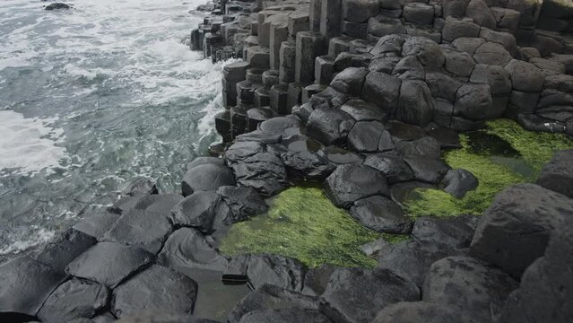 High angle view of waves splashing on Giant's Causeway basalt columns / Londonderry, Northern Ireland