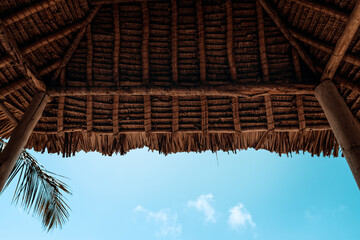 Fototapeta na wymiar Reed covered cabana roof an a tropical beach