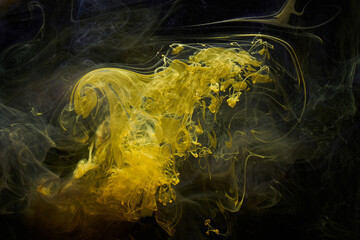 Fototapeta premium Yellow dark abstract background, luxury colored smoke, acrylic paint underwater explosion, cosmic swirling ink