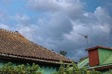 Blue sky over the roof of a rural house