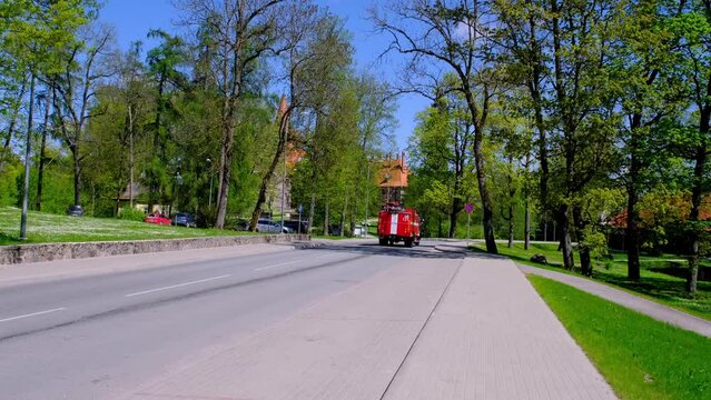 Cesvaine, Latvia - 16 JUNE, 2022: A fire truck moves through a small Latvian town